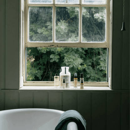 Bathroom window with toiletries and view of greenery
