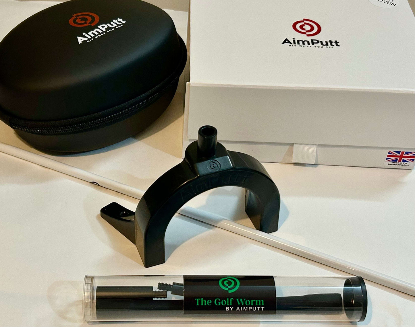AimPutt golf training aid with case and packaging on a white surface
