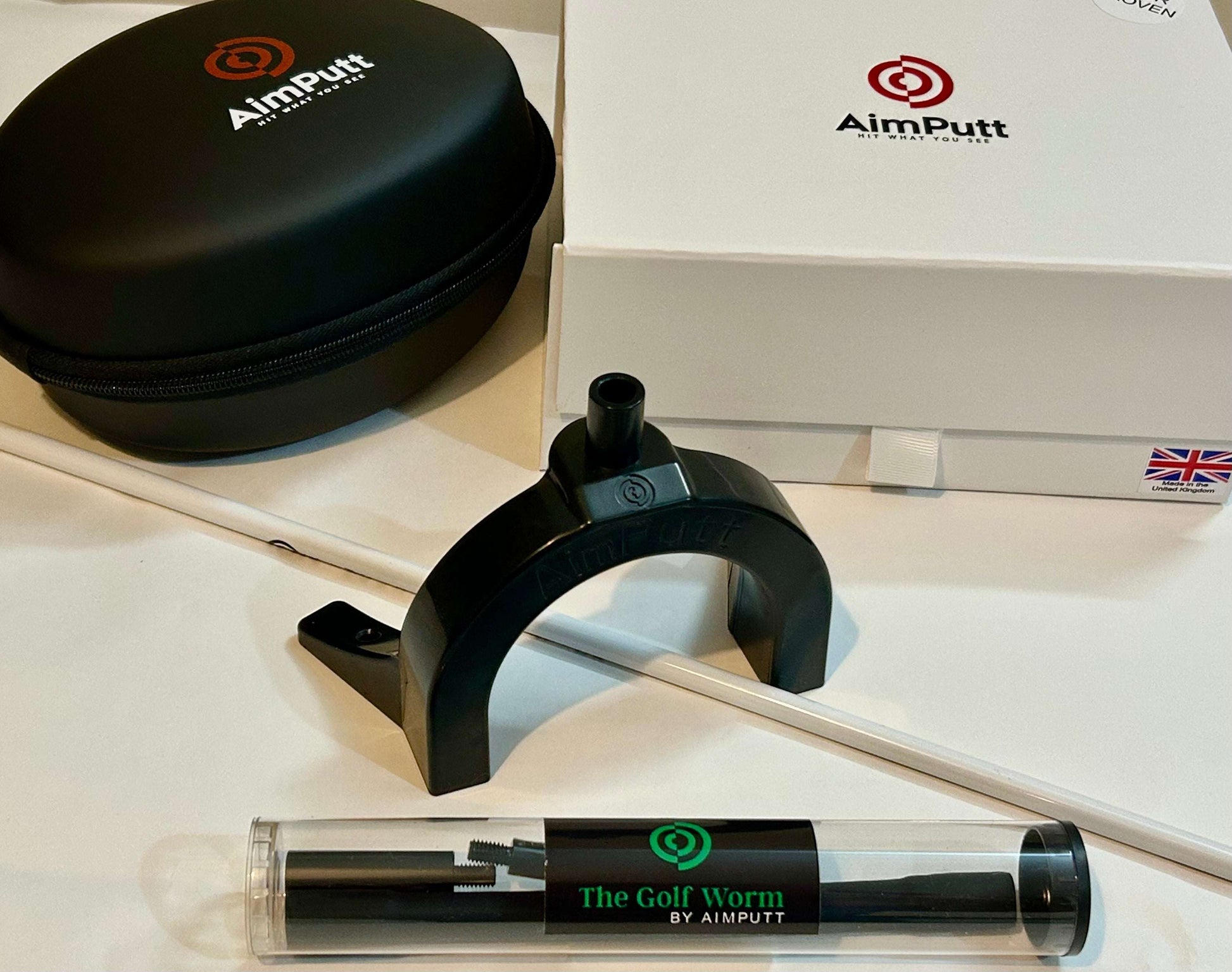 AimPutt golf training aid with case and packaging on a white surface