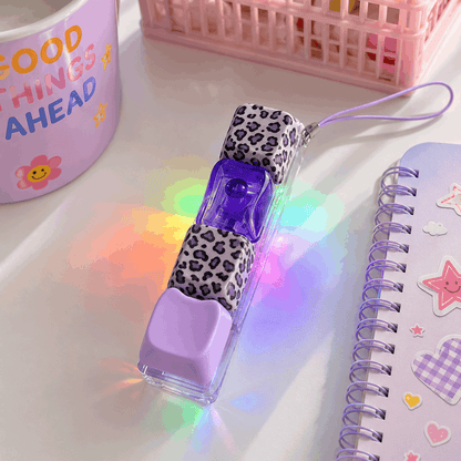 LED light-up pen with leopard print case on a white surface with colorful lighting effects.