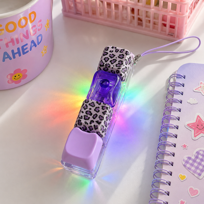LED light-up pen with leopard print case on a white surface with colorful lighting effects.