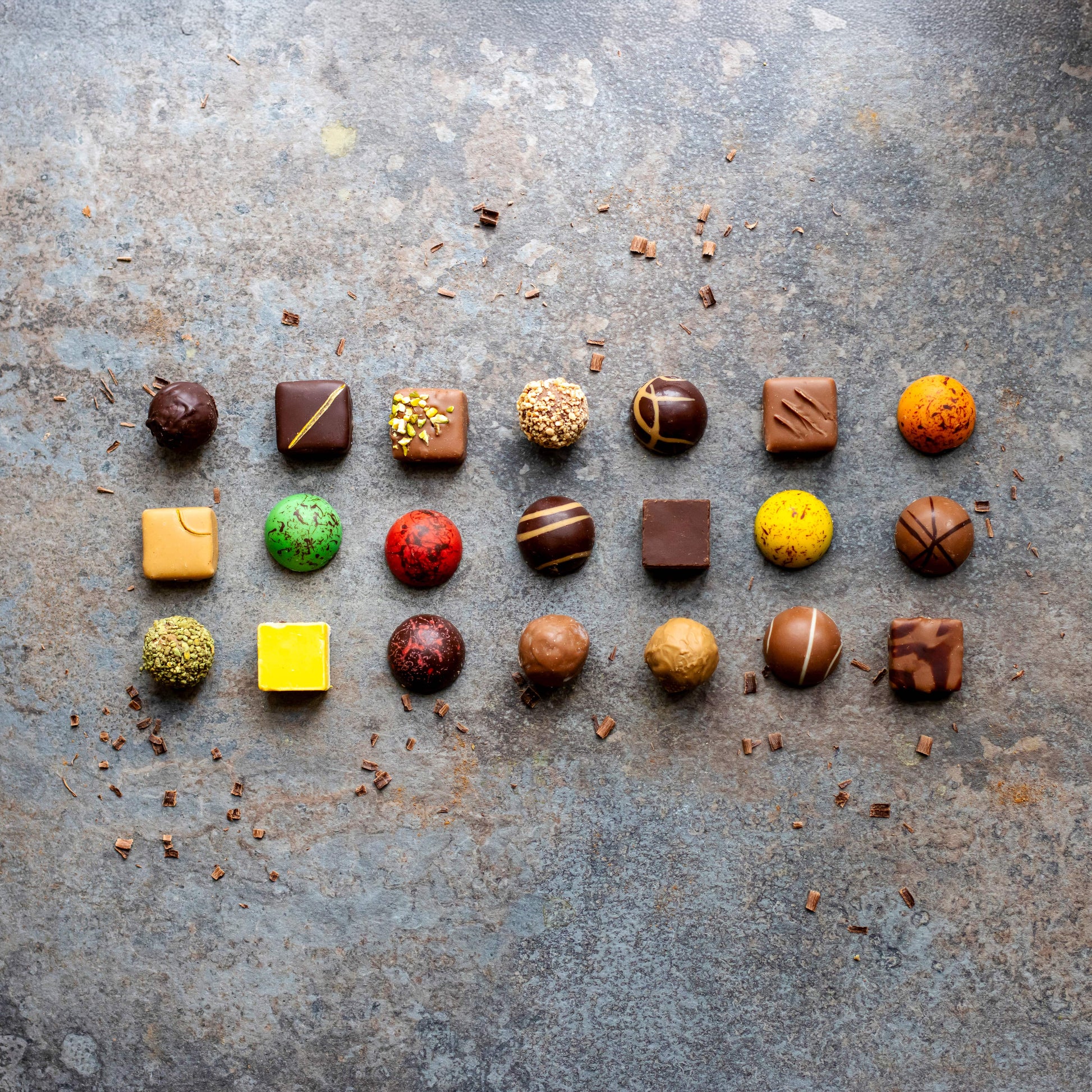 Assorted chocolate truffles on a textured surface