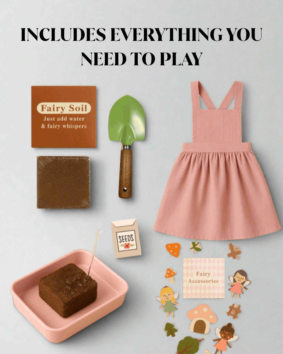 Collection of items including a pink dress, fairy soil, trowel, and fairy accessories on a light gray background.