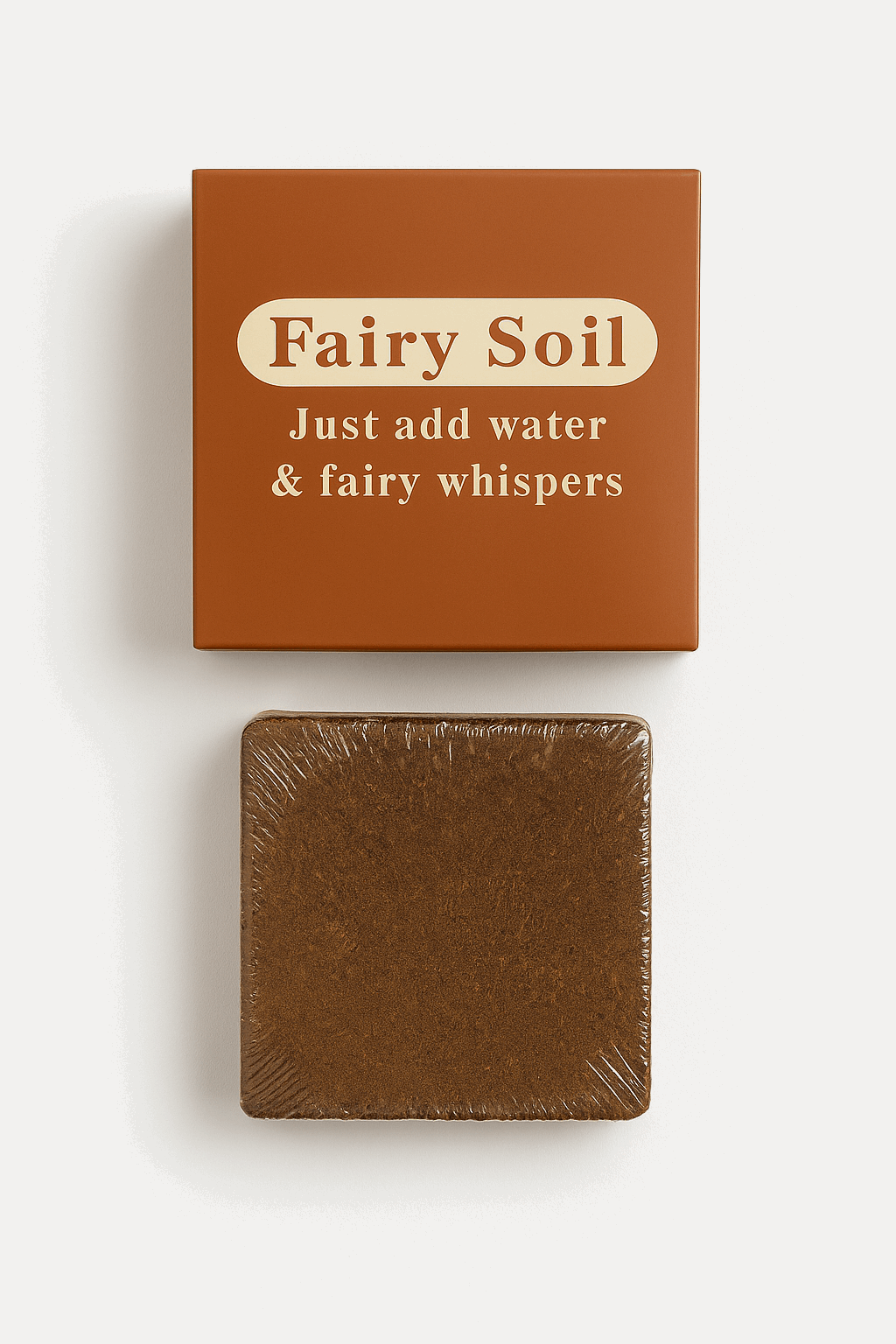 Box of 'Fairy Soil' with a bar of brown soap on a white background