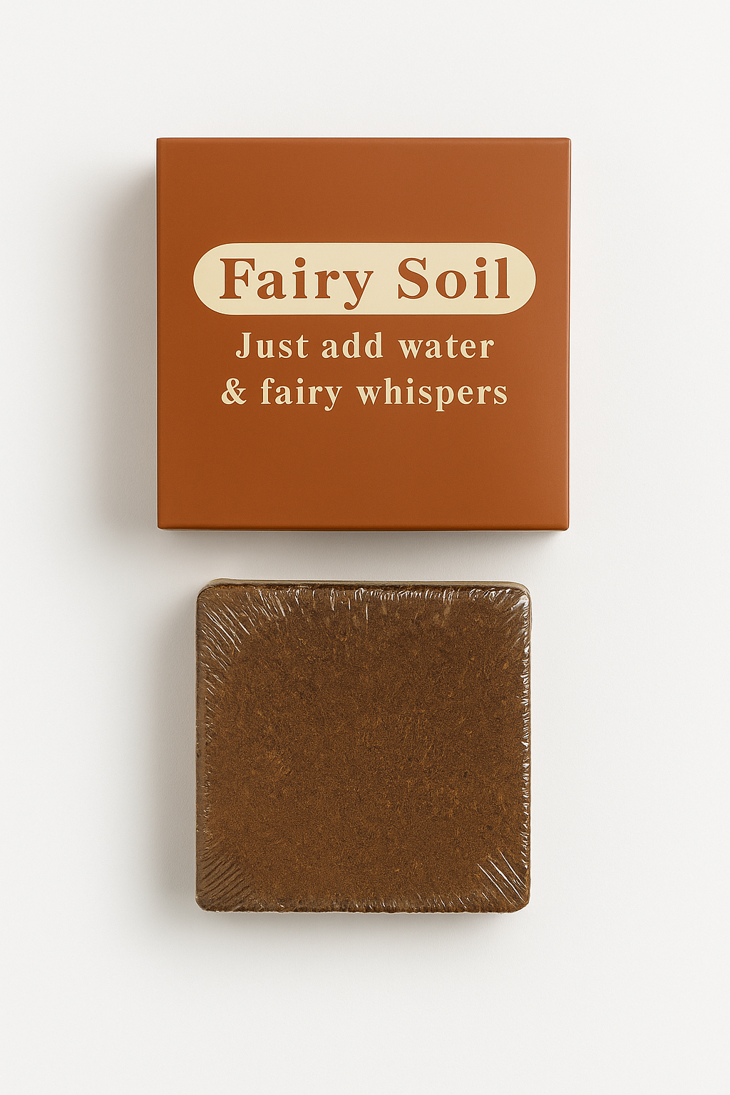 Box of 'Fairy Soil' with a bar of brown soap on a white background