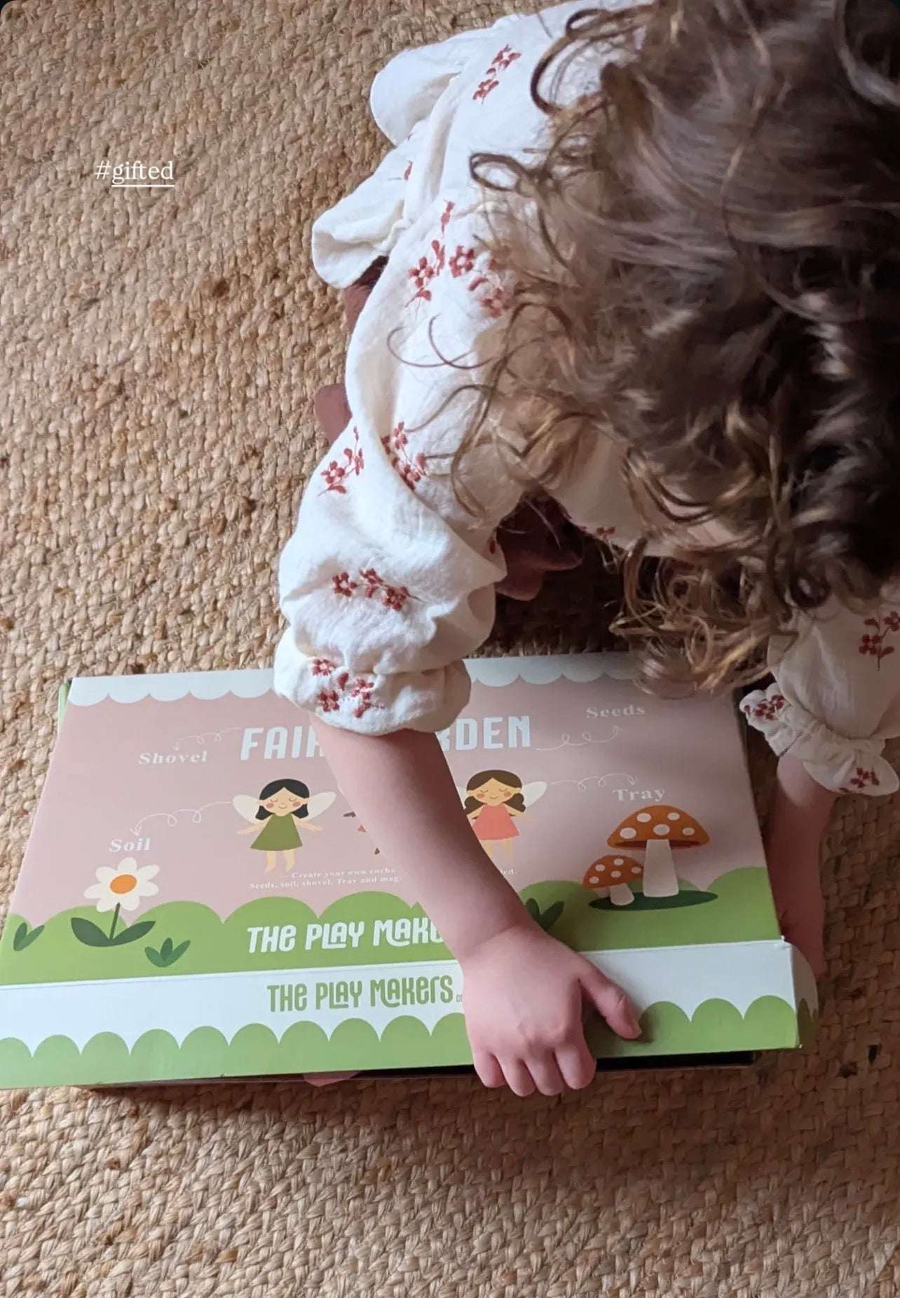 Child playing with a fairy-themed play set on a carpeted floor