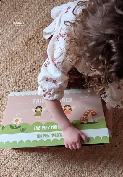 Child playing with a fairy-themed play set on a carpeted floor