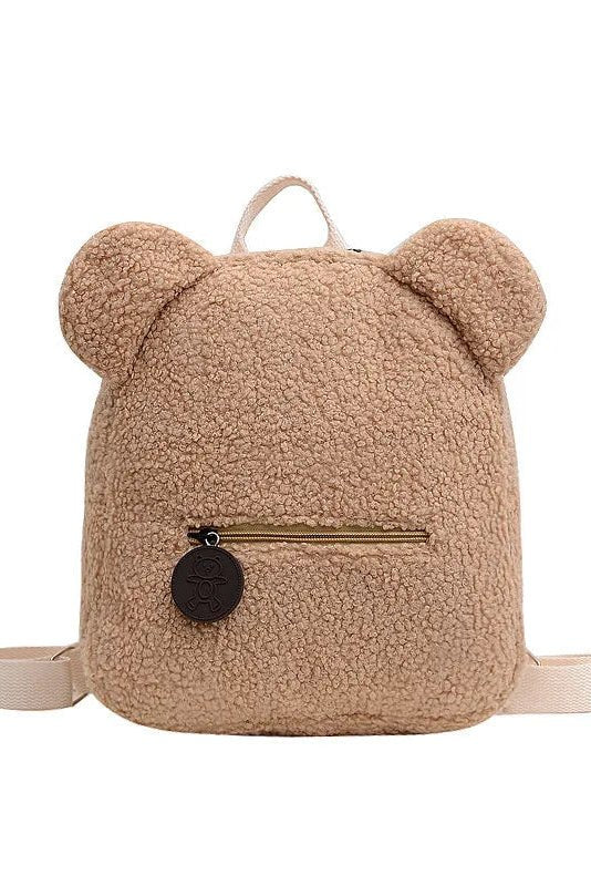 Beige teddy bear-shaped backpack with a gold zipper on a white background