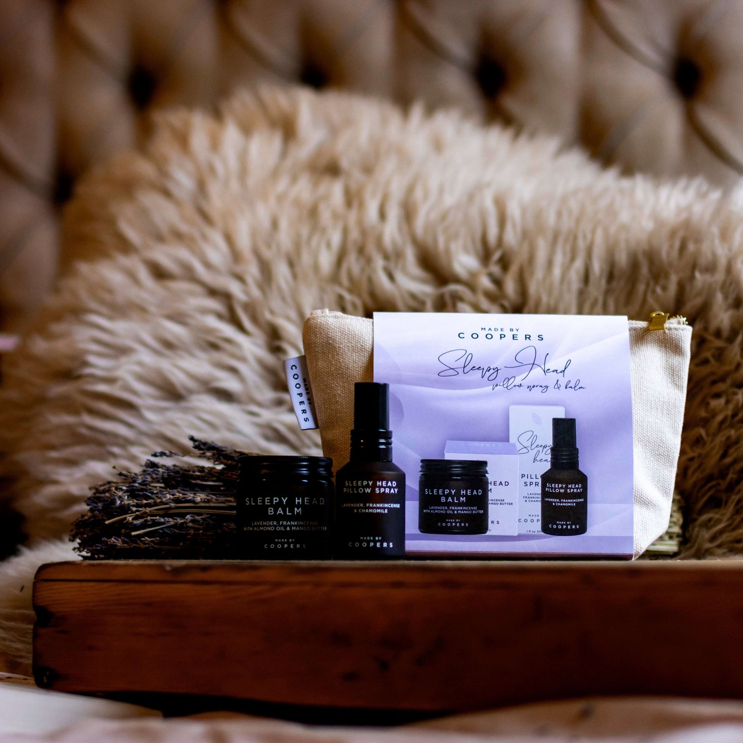 Cooper's skincare products on a wooden tray with a soft, textured background
