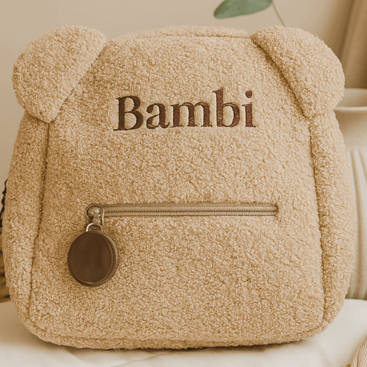 Beige teddy bear-shaped bag with 'Bambi' text on a light surface.