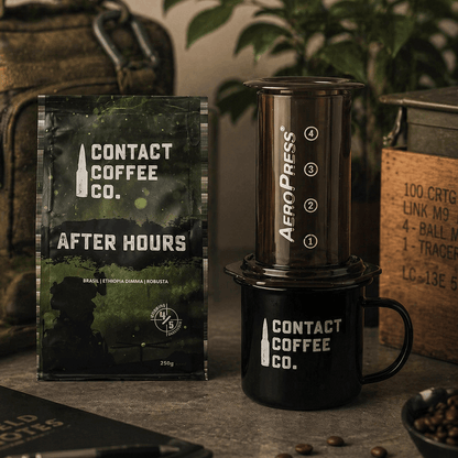Contact Coffee Co. packaging and Aeropress coffee maker on a table with coffee beans.