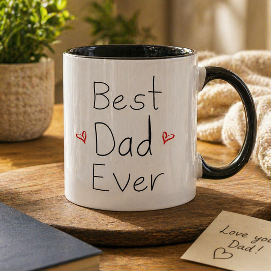 White mug with 'Best Dad Ever' text on a wooden surface with a plant and card in the background