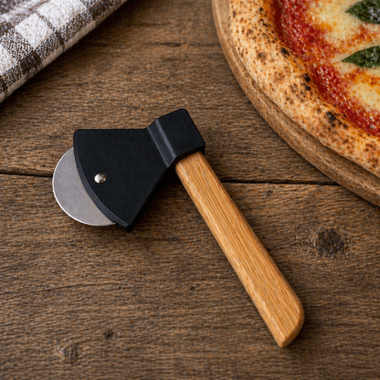 Pizza cutter with wooden handle and metal blade on a wooden surface next to a pizza.