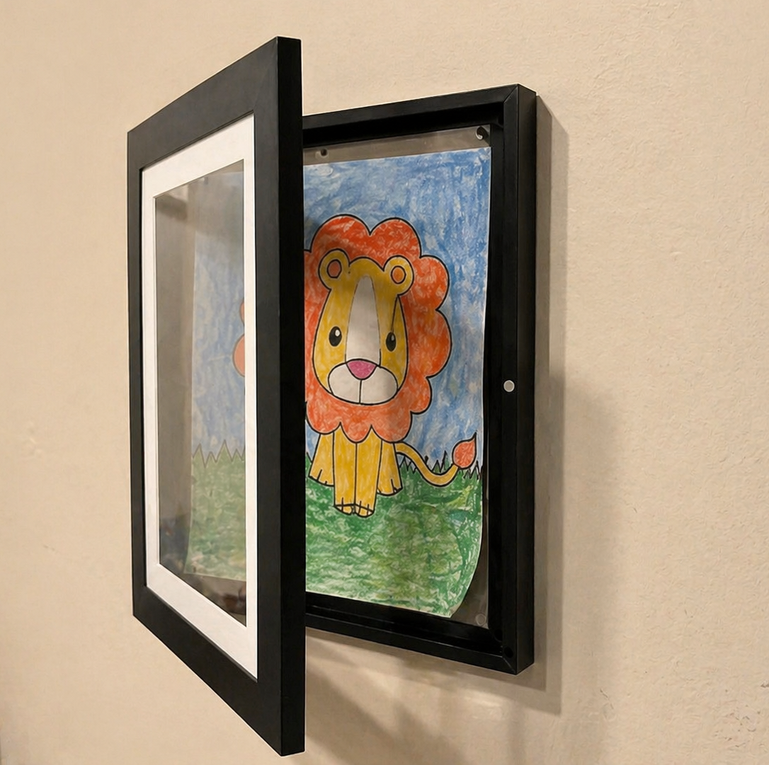 Children's drawing of a lion in a black frame on a beige wall.