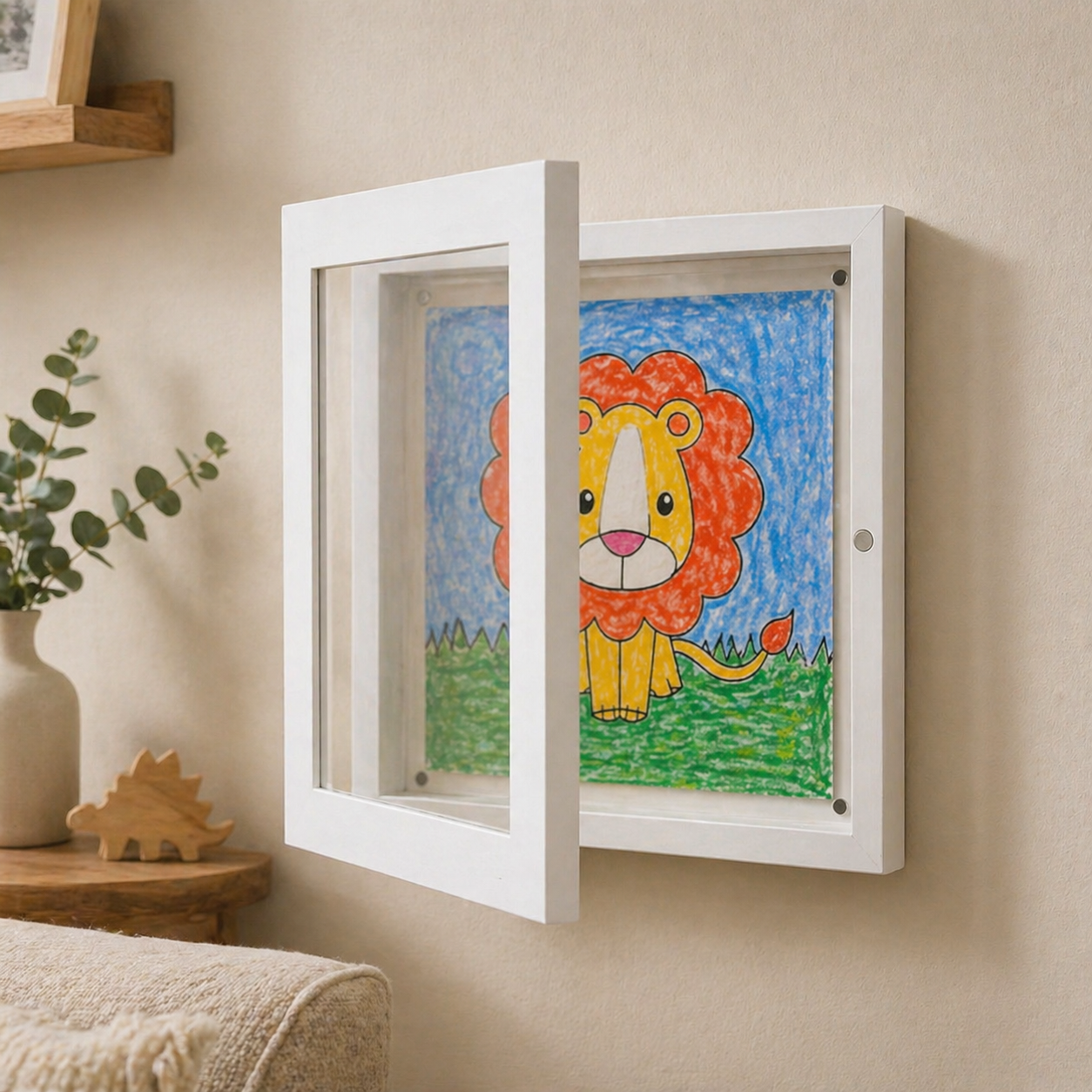 Children's drawing of a lion in a white frame on a beige wall.