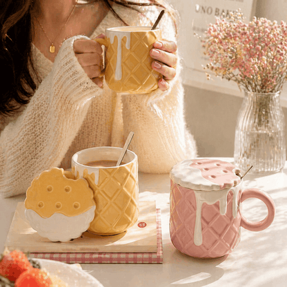 Person holding a yellow mug with waffle design, surrounded by similar mugs on a table.