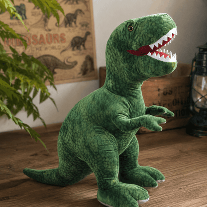 Green dinosaur plush toy on a wooden floor with a poster in the background