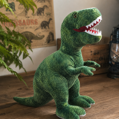 Green dinosaur plush toy on a wooden floor with a poster in the background