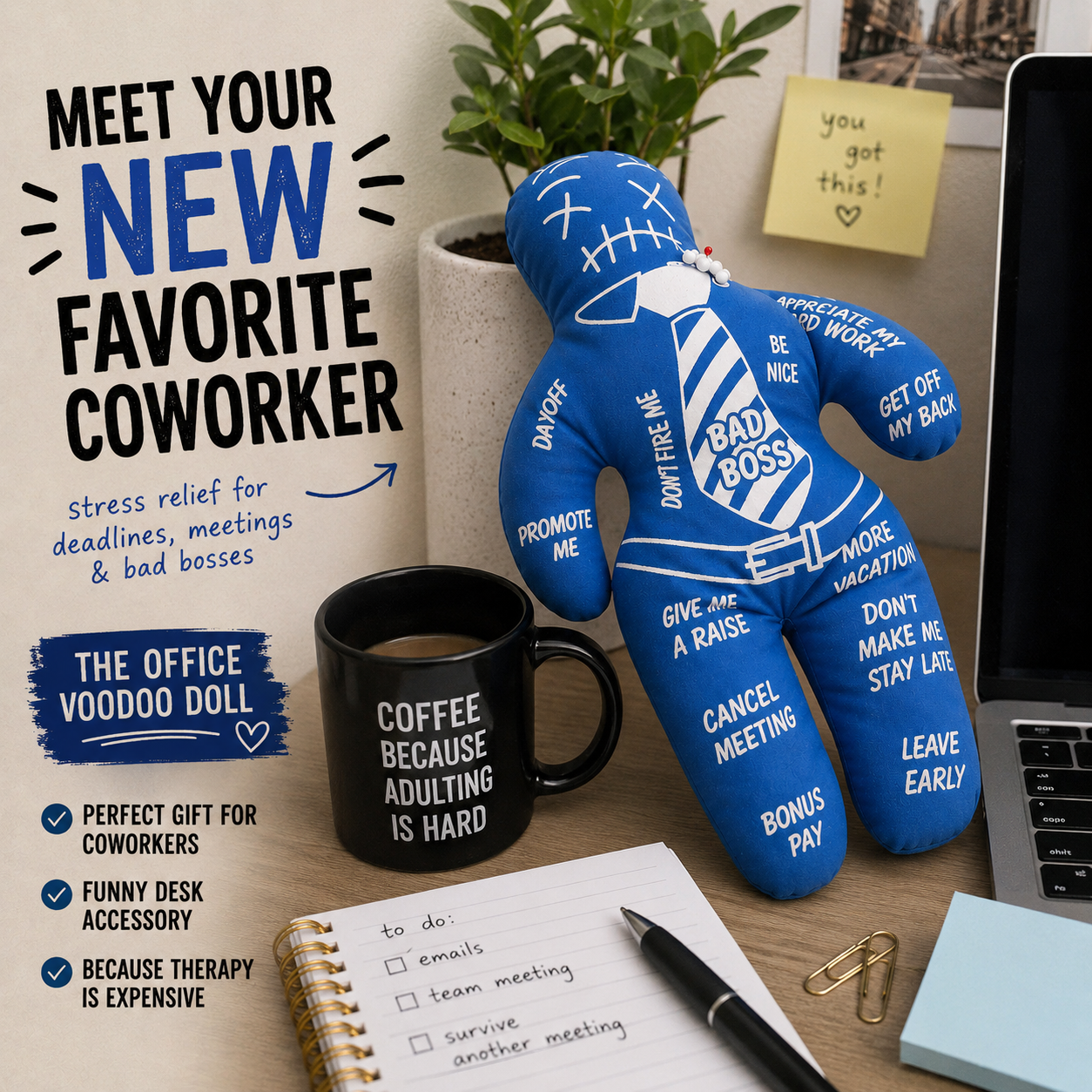 Blue office voodoo doll with humorous sayings on a desk with coffee mug and laptop.