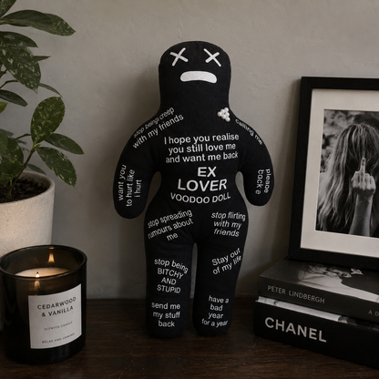 Ex Lover Voodoo Doll with a candle and books on a table