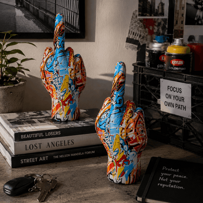 Colorful abstract sculpture on books with a motivational poster in the background