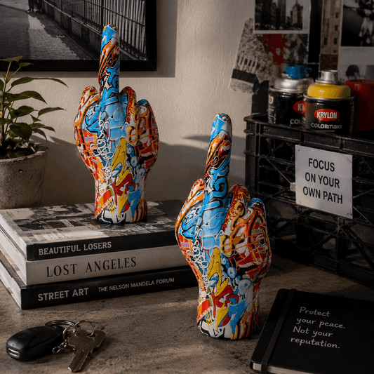 Colorful abstract sculpture on books with a motivational poster in the background