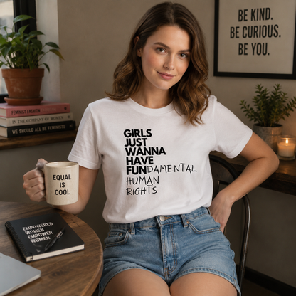 Woman wearing a white t-shirt with a message, holding a mug, in a room with decor and books.