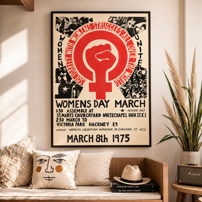 Framed poster of a Women's March event on a wall with decorative elements.