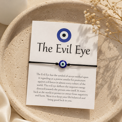 Evil Eye bracelet on a card with text on a beige plate