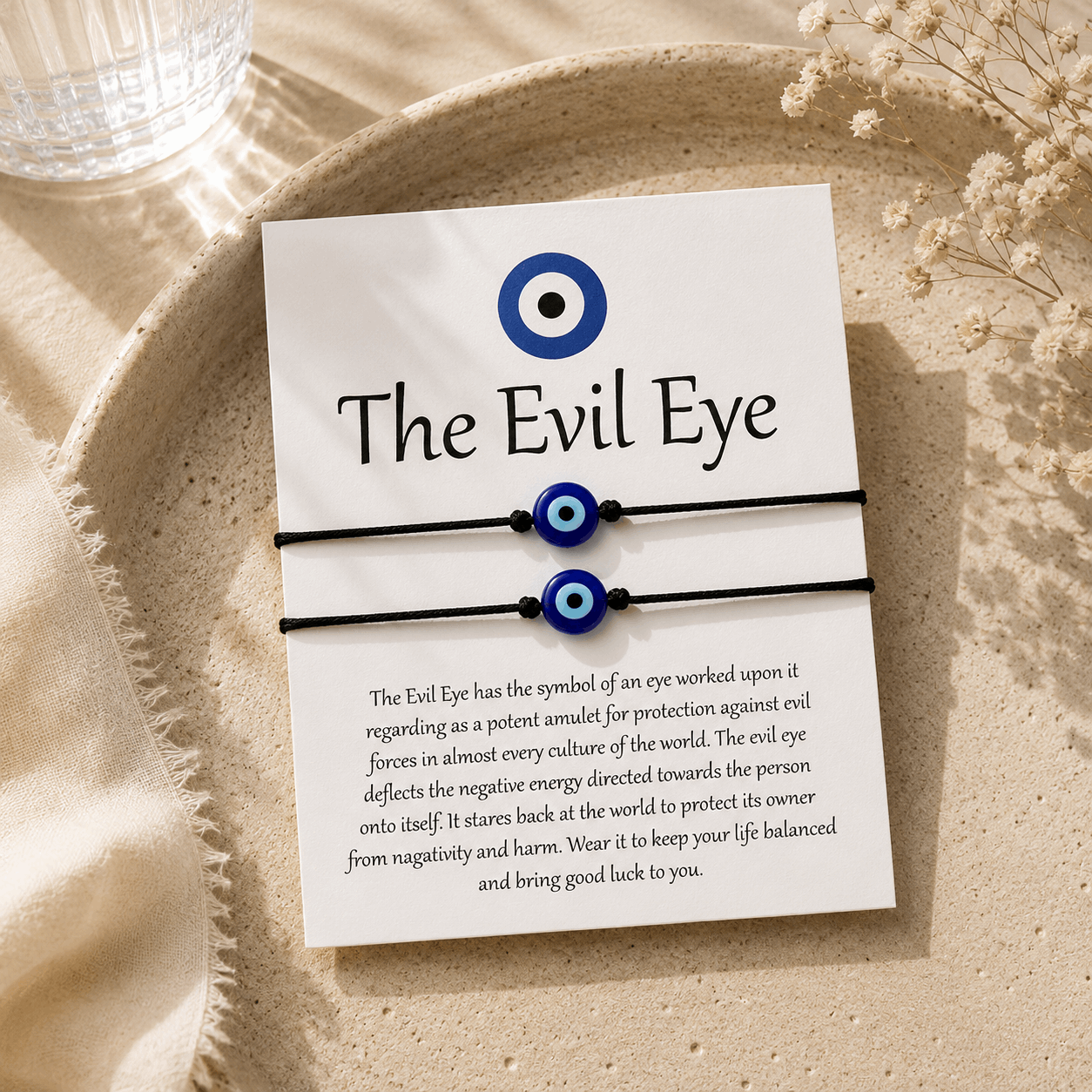 Evil eye bracelets on a card with text on a beige surface