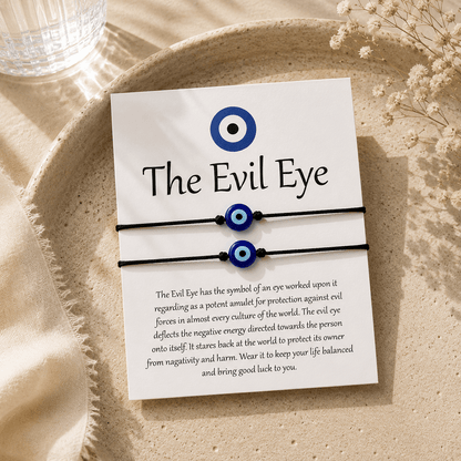 Evil eye bracelets on a card with text on a beige surface