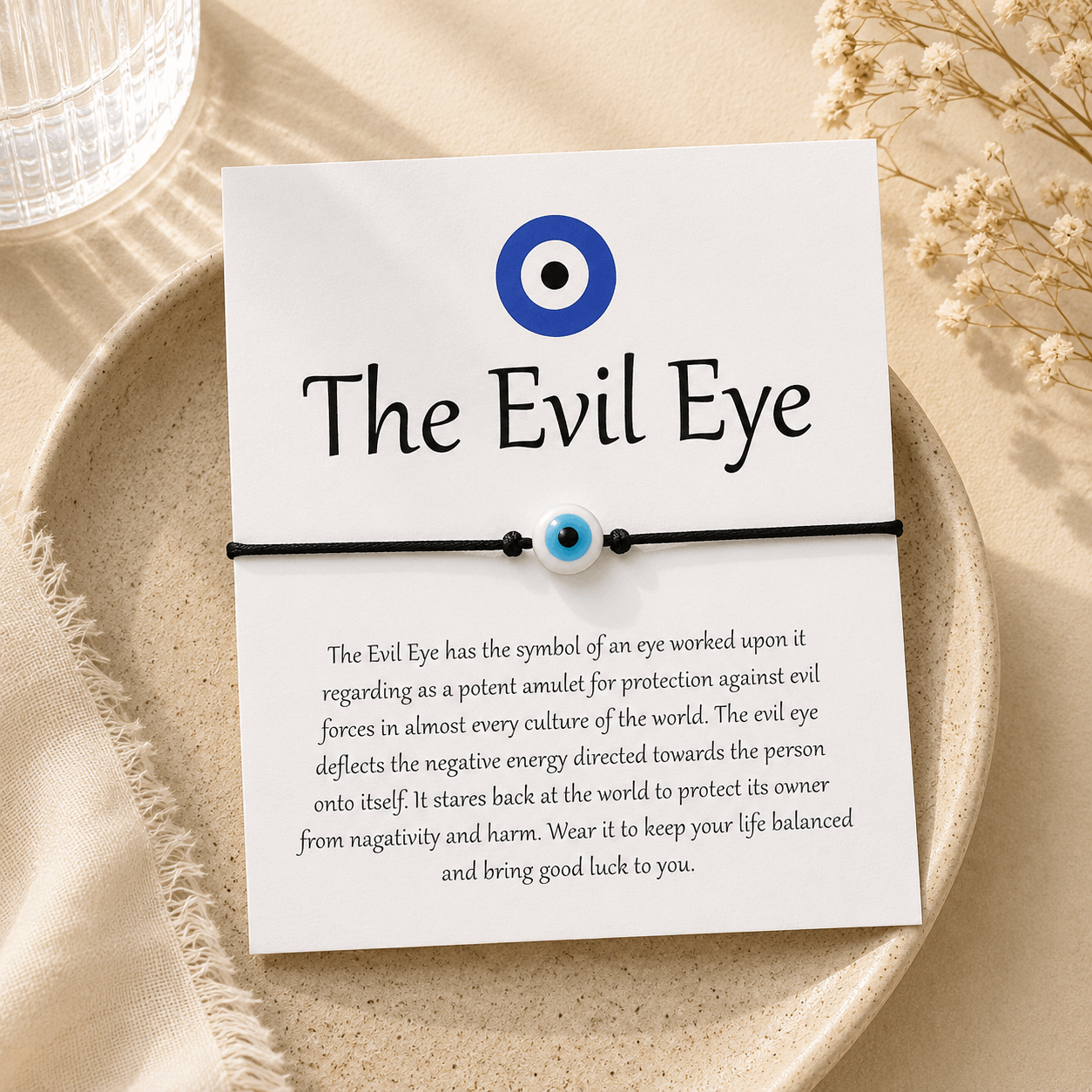 Evil eye bracelet on a card with text on a beige background