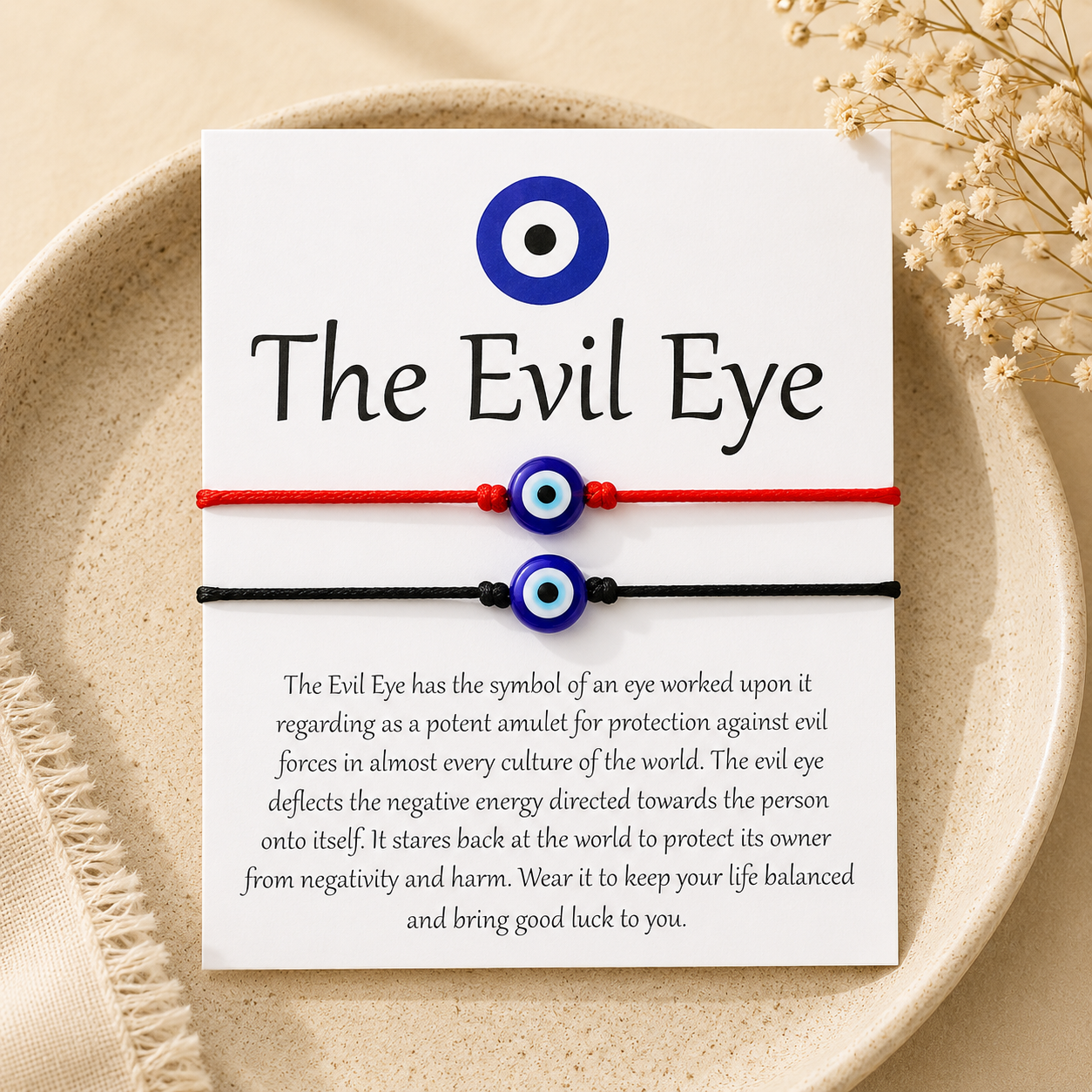Evil eye bracelet on a card with text about its meaning, displayed on a beige plate.