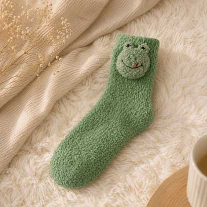 Green knitted sock with a face design on a soft surface