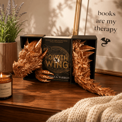 Book with dragon design on cover, surrounded by decorative elements on a wooden surface.