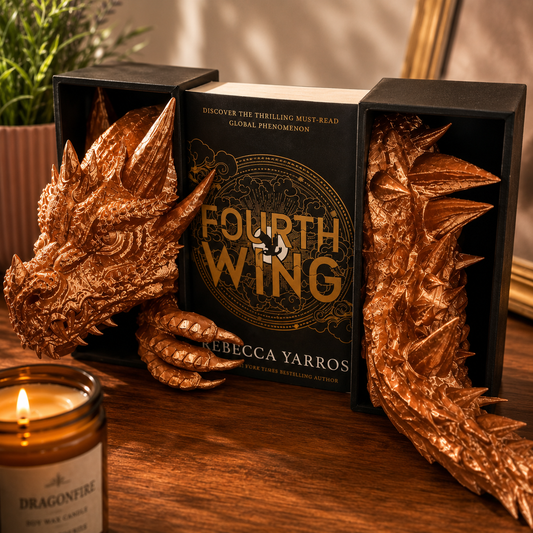 Book titled 'Fourth Wing' by Rebecca Yarros with dragon-themed bookends on a wooden surface.