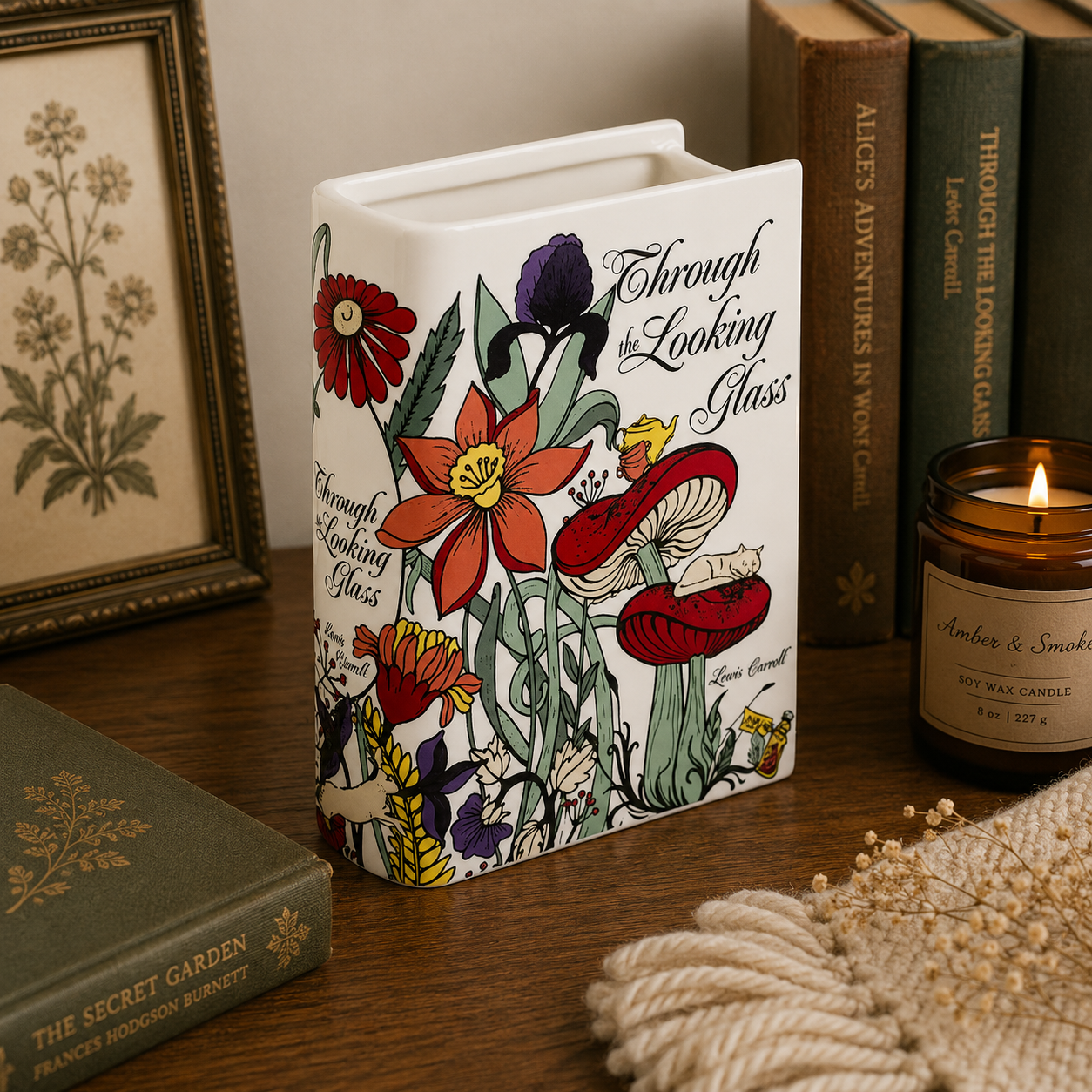 Decorative book-shaped candle with floral design and text on a wooden surface.