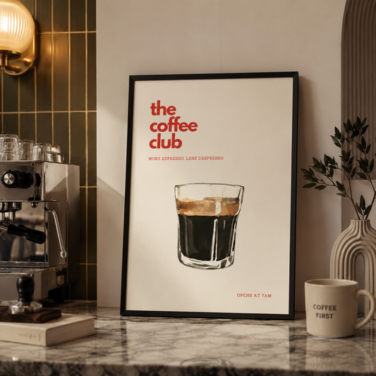 Framed poster of 'the coffee club' with a glass of coffee on a countertop with coffee-making equipment.