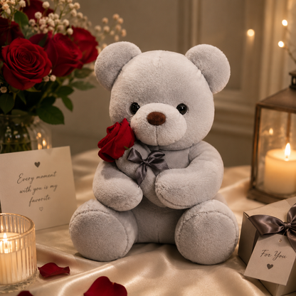 Gray teddy bear with a red rose on a romantic setting with candles and flowers.