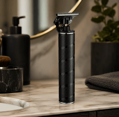 Black electric shaver on a marble countertop with bathroom items in the background