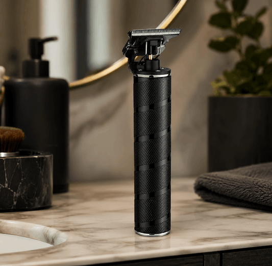 Black electric shaver on a marble countertop with bathroom items in the background