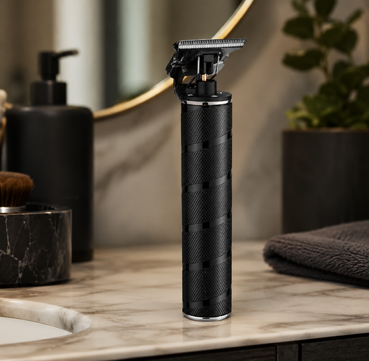Black electric shaver on a marble countertop with bathroom items in the background