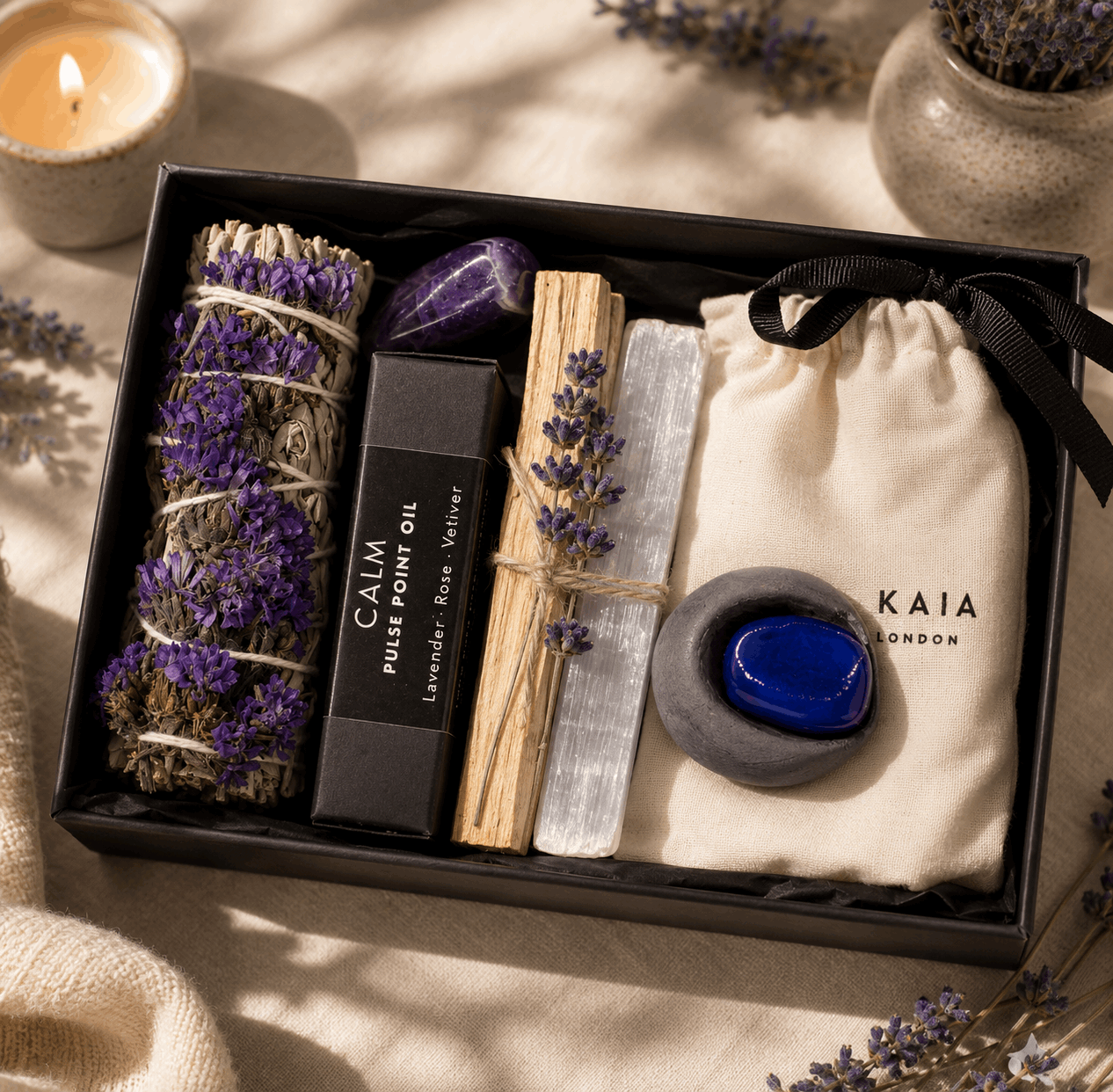 Gift set with lavender, palm oil, and other items in a black box on a soft background.