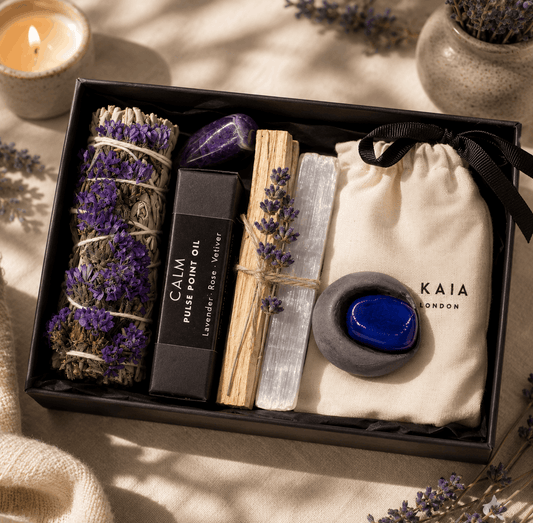 Gift set with lavender, palm oil, and other items in a black box on a soft background.