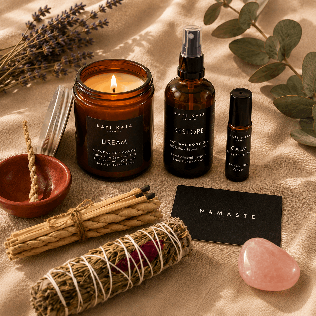Kati Kaia products including a candle, oil, and essential oils on a textured surface with lavender and eucalyptus.