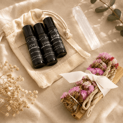 Set of rollerball bottles labeled 'Joy', 'Love', and 'Calm' with decorative elements on a neutral background.