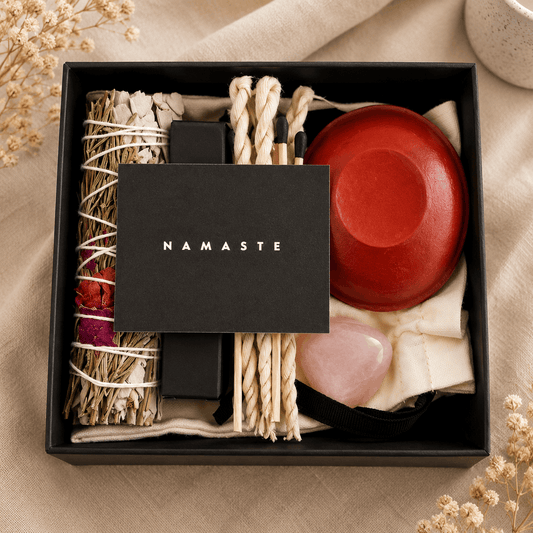 Gift box with 'Namaste' branding containing various items on a beige background.