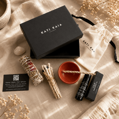 Kati Kaia products including a black box, incense sticks, a bowl, and a bottle on a textured surface.