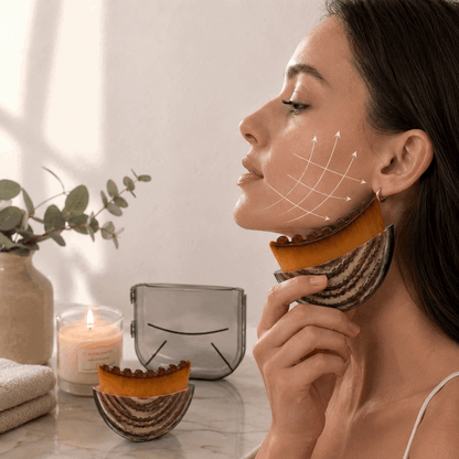 Woman applying a facial mask with a decorative bowl and candle in the background