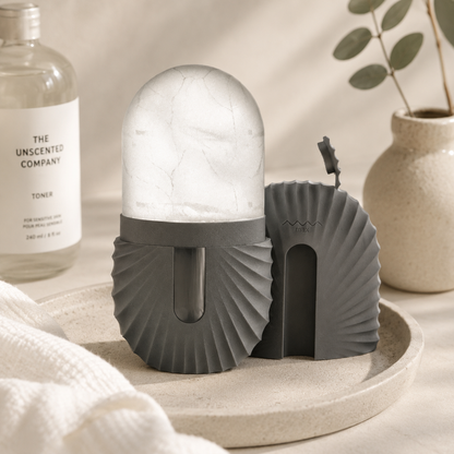 Gray and white lamp with pleated design on a neutral background